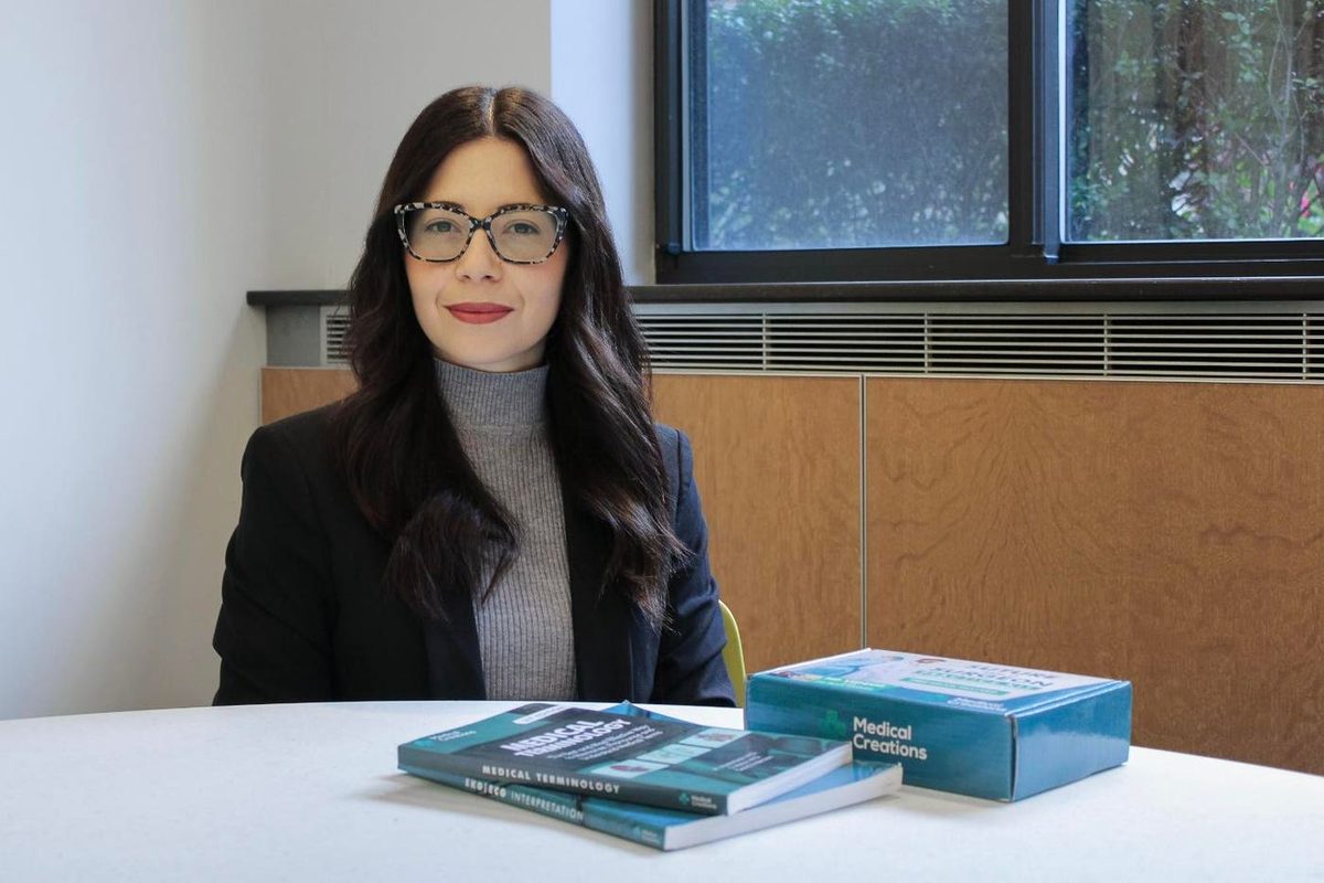 Dr. Sabrina Meloni, co-founder of Medical Creations, with our books and Suture Practice Kit